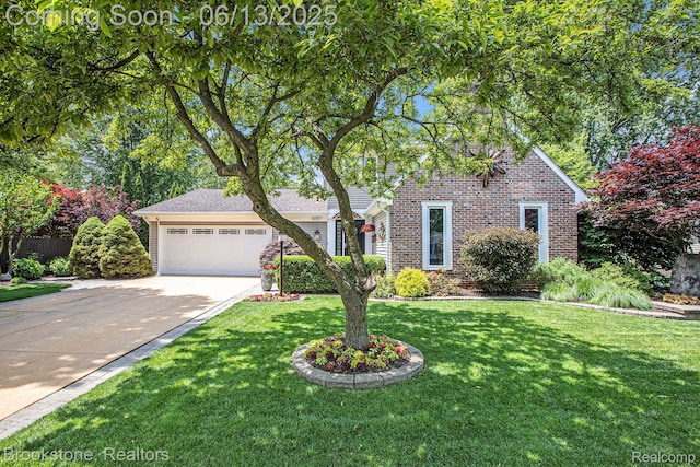 4057 Cypress Dr, Troy, MI 48085 - traditional-style house with a garage, concrete driveway, brick siding, and a front yard
