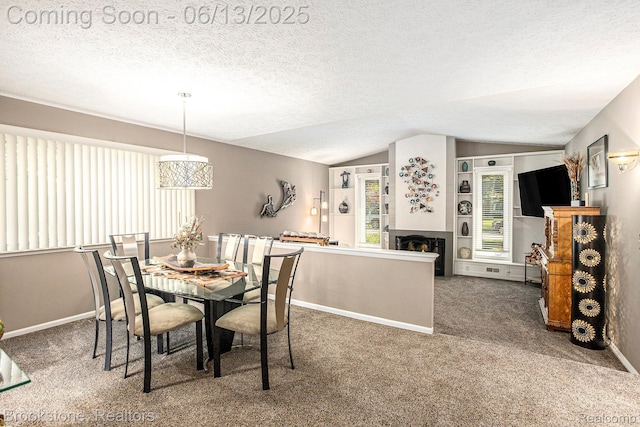 4057 Cypress Dr, Troy, MI 48085 - carpeted dining area with vaulted ceiling, baseboards, a textured ceiling, and a fireplace