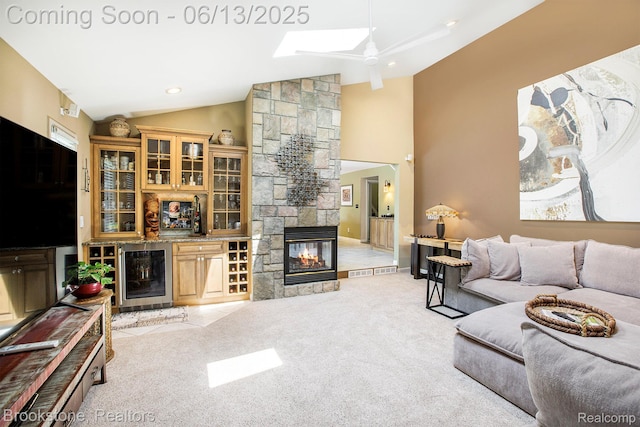 4057 Cypress Dr, Troy, MI 48085 - living area featuring wine cooler, lofted ceiling, light colored carpet, ceiling fan, and a stone fireplace