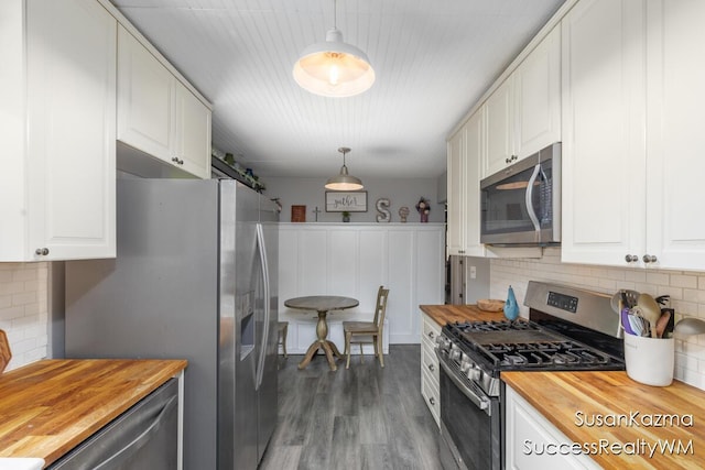111 W 1st Ave, Plainwell, MI 49080 - kitchen featuring wood counters, stainless steel appliances, backsplash, white cabinetry, and wood finished floors