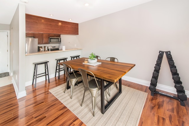 855 S Pontiac Trl Unit A305, Walled Lake, MI 48390 - dining space with wood finished floors, baseboards, and recessed lighting
