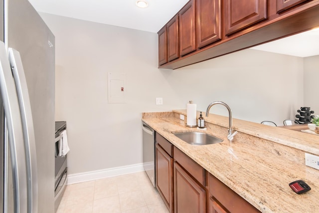 855 S Pontiac Trl Unit A305, Walled Lake, MI 48390 - kitchen featuring a sink, baseboards, appliances with stainless steel finishes, light stone countertops, and light tile patterned flooring