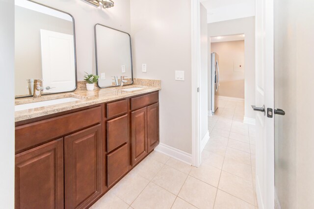 855 S Pontiac Trl Unit A305, Walled Lake, MI 48390 - bathroom featuring tile patterned flooring, double vanity, and baseboards