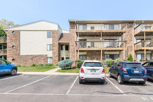 855 S Pontiac Trl Unit A305, Walled Lake, MI 48390 - view of property featuring uncovered parking
