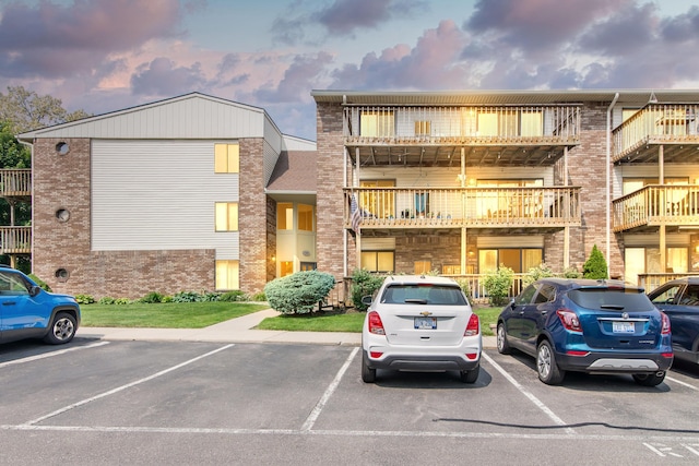 855 S Pontiac Trl Unit A305, Walled Lake, MI 48390 - view of property featuring uncovered parking