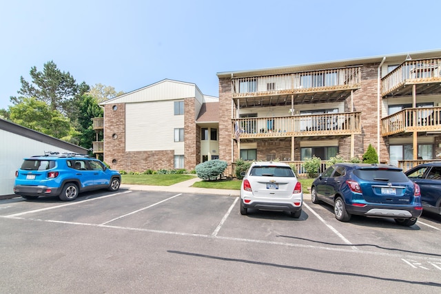 855 S Pontiac Trl Unit A305, Walled Lake, MI 48390 - view of building exterior featuring uncovered parking