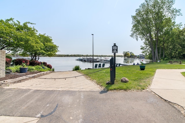 855 S Pontiac Trl Unit A305, Walled Lake, MI 48390 - view of front of house featuring a front lawn, a water view, and a boat ramp
