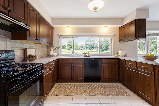 1349 King George Blvd, Ann Arbor, MI 48108 - kitchen featuring black appliances, a sink, under cabinet range hood, light countertops, and tasteful backsplash
