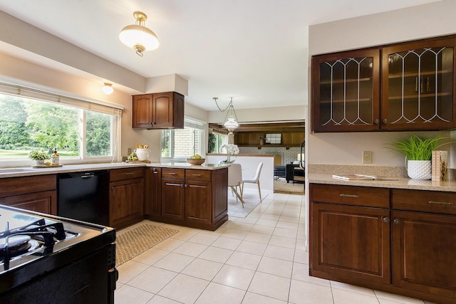 1349 King George Blvd, Ann Arbor, MI 48108 - kitchen with black appliances, light countertops, light tile patterned floors, decorative light fixtures, and a peninsula