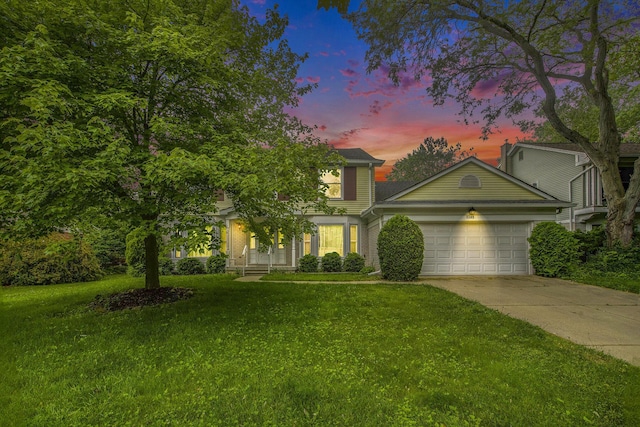 1349 King George Blvd, Ann Arbor, MI 48108 - view of front of house with a garage, a lawn, and driveway