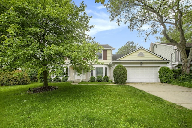 1349 King George Blvd, Ann Arbor, MI 48108 - view of front of home featuring an attached garage, a front lawn, and driveway