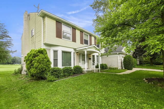 1349 King George Blvd, Ann Arbor, MI 48108 - colonial house with a chimney and a front lawn
