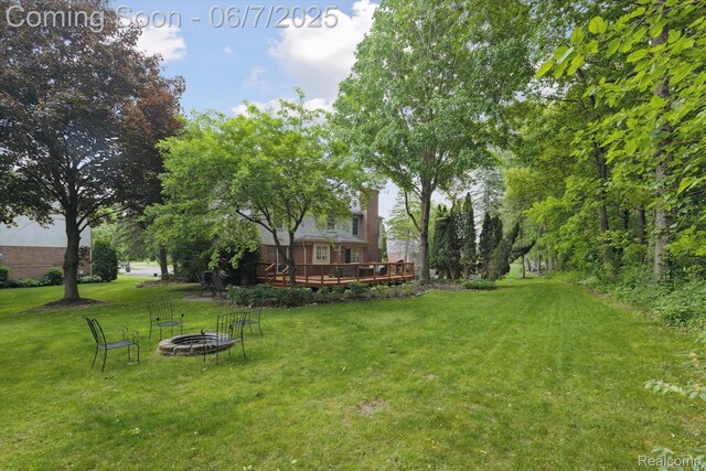 3753 Rolling Hills Rd, Lake Orion, MI 48359 - view of green lawn with an outdoor fire pit and a deck