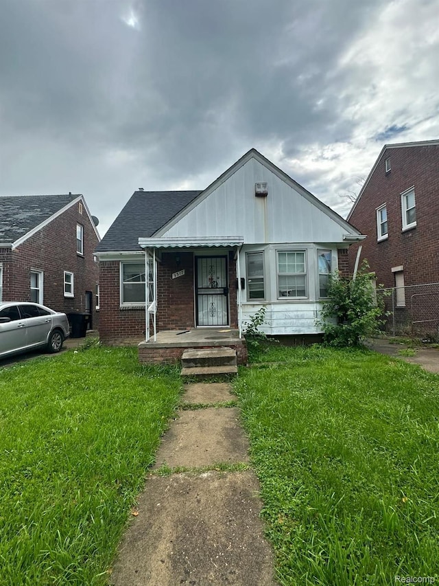 9317 Ward St, Detroit, MI 48228 - bungalow-style house featuring brick siding, covered porch, and board and batten siding