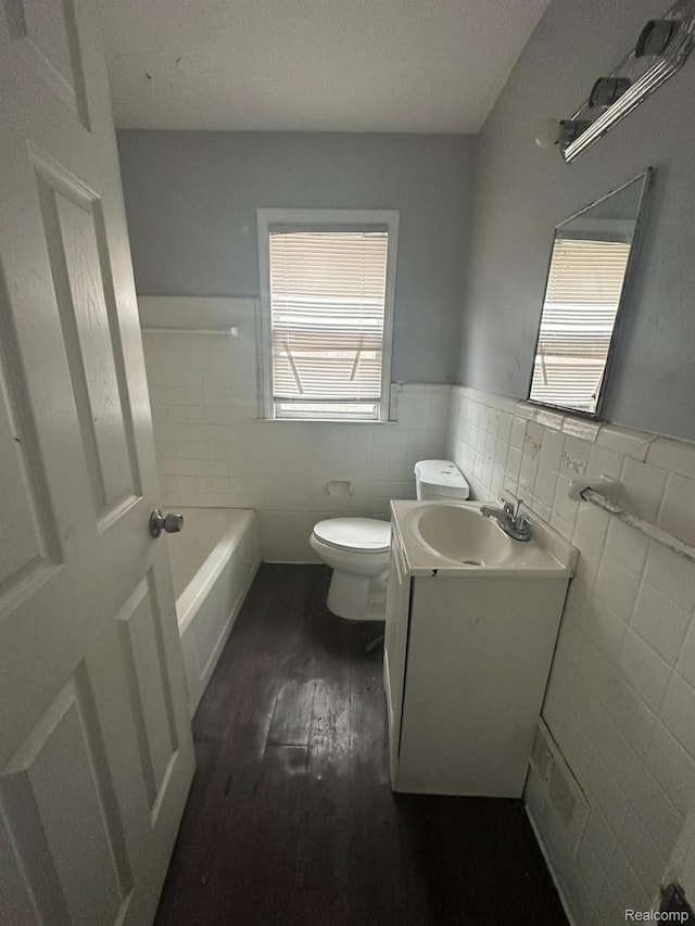 9317 Ward St, Detroit, MI 48228 - full bath with tile walls, wood finished floors, vanity, toilet, and wainscoting