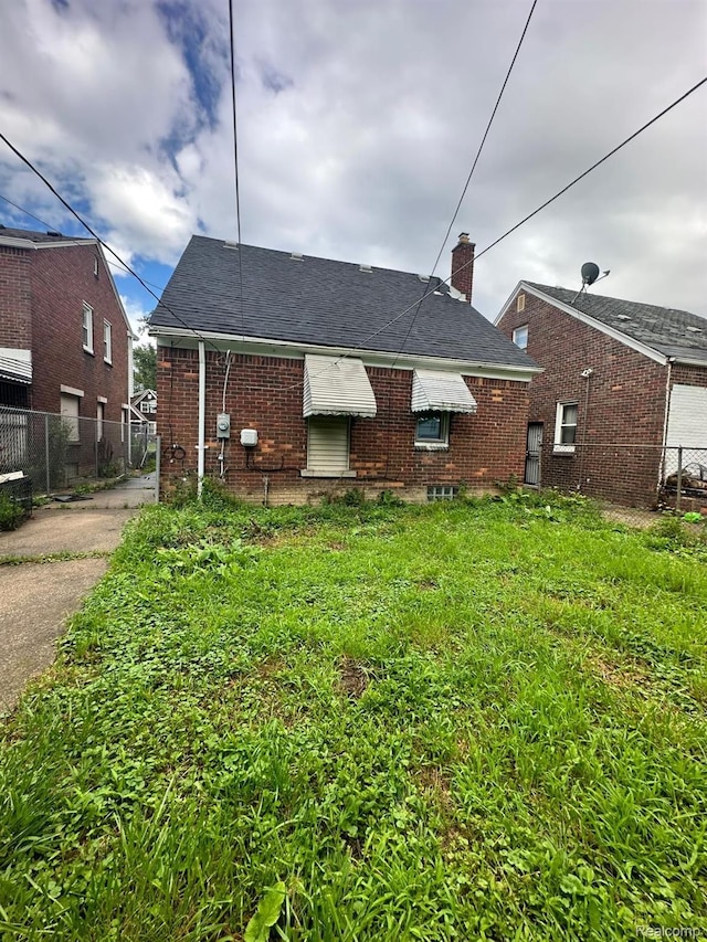 9317 Ward St, Detroit, MI 48228 - rear view of property with a chimney and brick siding