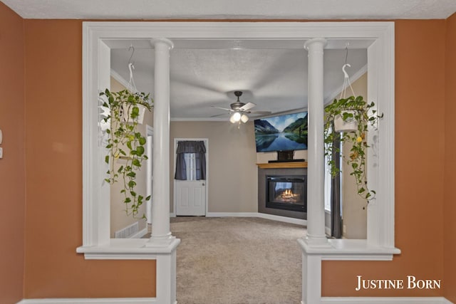 2264 Stafford Ave SW, Grand Rapids, MI 49507 - unfurnished living room with a glass covered fireplace, carpet floors, ceiling fan, ornamental molding, and baseboards