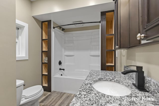 2264 Stafford Ave SW, Grand Rapids, MI 49507 - full bathroom featuring toilet, wood finished floors, washtub / shower combination, and vanity