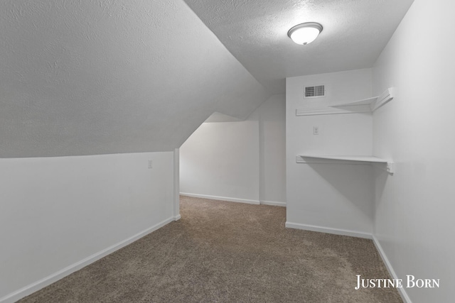 2264 Stafford Ave SW, Grand Rapids, MI 49507 - walk in closet featuring carpet flooring and lofted ceiling