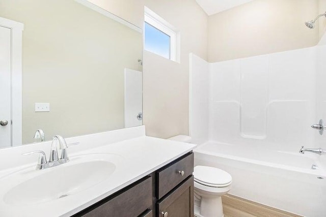 6218 Sturgeon Run, Muskegon, MI 49444 - full bath featuring toilet, bathtub / shower combination, vanity, and wood finished floors