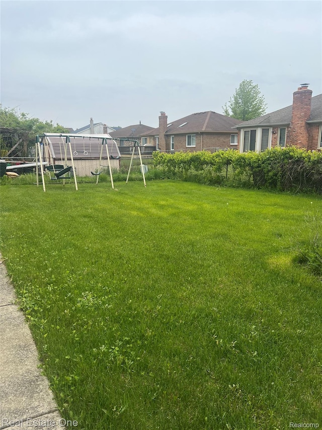 35715 Maureen Dr, Sterling Heights, MI 48310 - view of green lawn with a playground