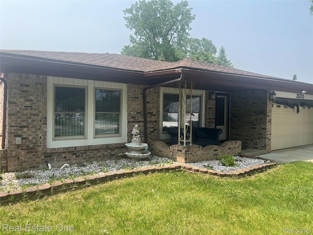 35715 Maureen Dr, Sterling Heights, MI 48310 - view of front facade featuring brick siding, roof with shingles, an attached garage, concrete driveway, and a front lawn