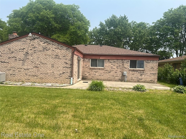 35715 Maureen Dr, Sterling Heights, MI 48310 - rear view of property with a patio area, brick siding, and a yard
