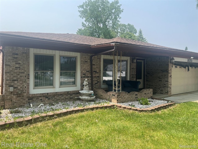 35715 Maureen Dr, Sterling Heights, MI 48310 - view of front of house featuring brick siding, roof with shingles, a garage, concrete driveway, and a front yard