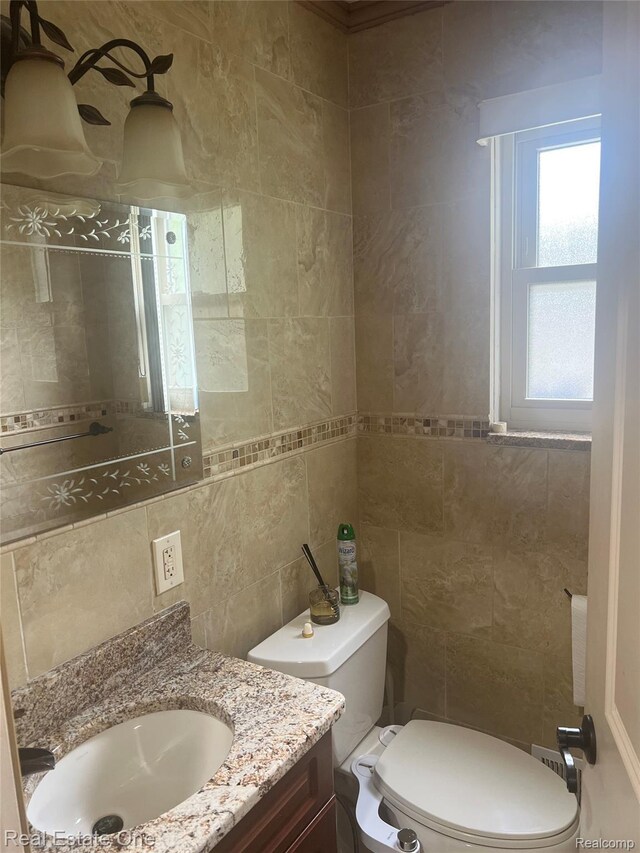 35715 Maureen Dr, Sterling Heights, MI 48310 - bathroom featuring tile walls, toilet, vanity, and tasteful backsplash
