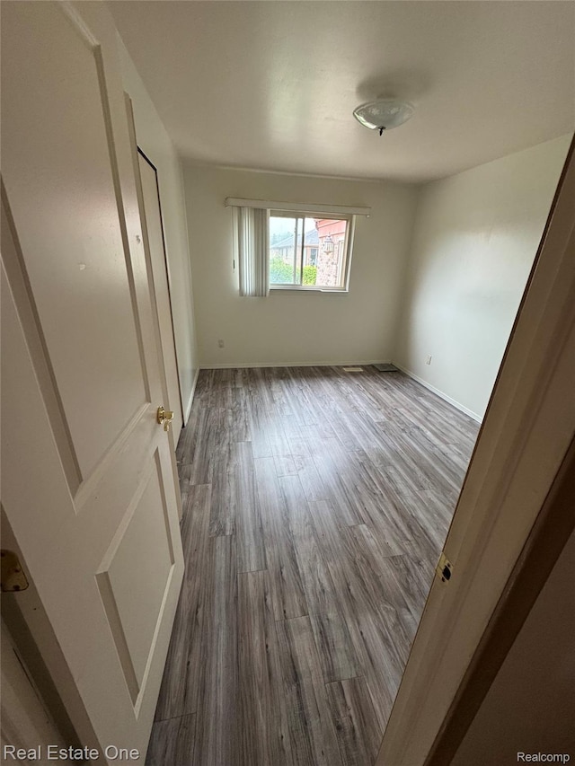 35715 Maureen Dr, Sterling Heights, MI 48310 - unfurnished bedroom featuring wood finished floors and baseboards