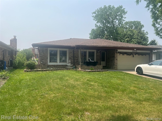 35715 Maureen Dr, Sterling Heights, MI 48310 - view of front facade with brick siding, a garage, and a front lawn