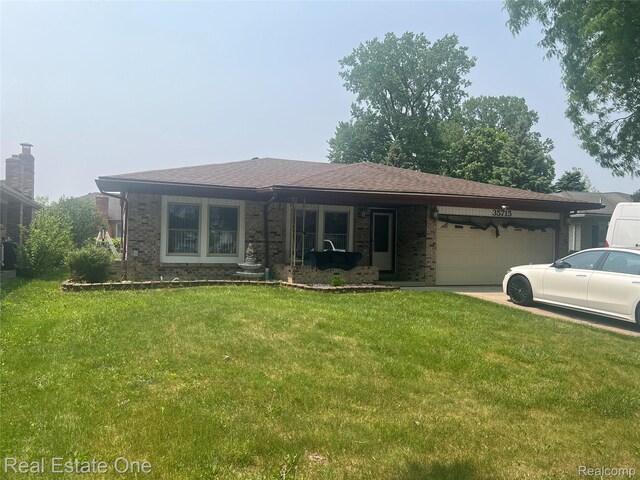 35715 Maureen Dr, Sterling Heights, MI 48310 - ranch-style home featuring an attached garage, brick siding, a front lawn, and driveway