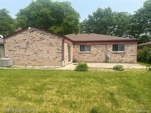 35715 Maureen Dr, Sterling Heights, MI 48310 - view of front of house with a patio, cooling unit, brick siding, and a front yard