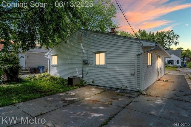 14920 Myola Ave, Warren, MI 48089 - property exterior at dusk with a patio and a chimney