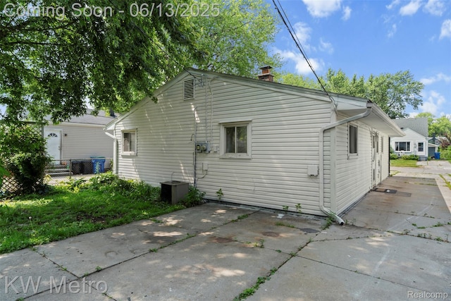 14920 Myola Ave, Warren, MI 48089 - rear view of property featuring a patio and a chimney