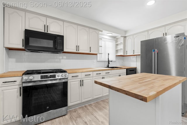 14920 Myola Ave, Warren, MI 48089 - kitchen with wooden counters, appliances with stainless steel finishes, white cabinetry, light wood-style flooring, and open shelves
