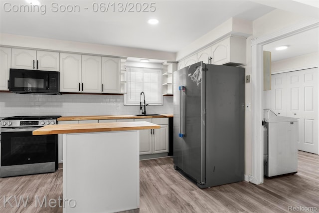 14920 Myola Ave, Warren, MI 48089 - kitchen featuring butcher block countertops, appliances with stainless steel finishes, decorative backsplash, and light wood-style flooring