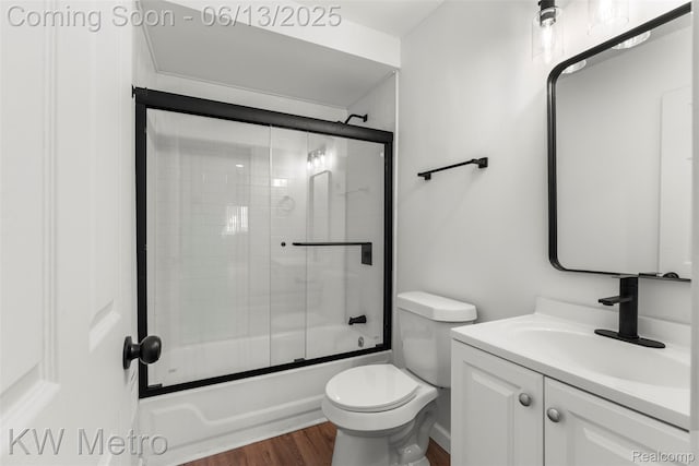 14920 Myola Ave, Warren, MI 48089 - bathroom with wood finished floors, vanity, and bath / shower combo with glass door