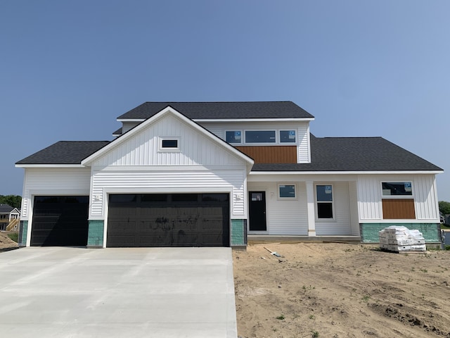 15765 Norwalk Rd, Grand Haven, MI 49417 - modern inspired farmhouse with an attached garage, concrete driveway, board and batten siding, and a shingled roof
