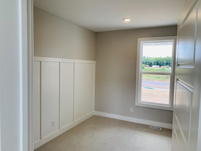 15765 Norwalk Rd, Grand Haven, MI 49417 - carpeted spare room with wainscoting and a decorative wall