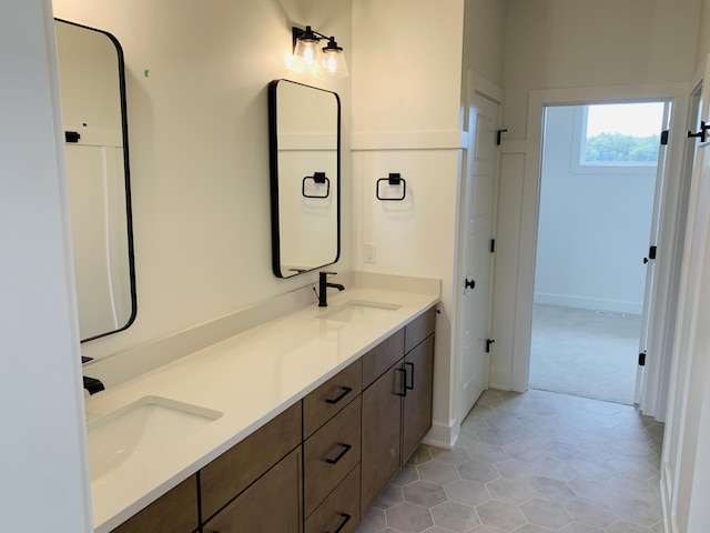 15765 Norwalk Rd, Grand Haven, MI 49417 - bathroom featuring double vanity and tile patterned floors