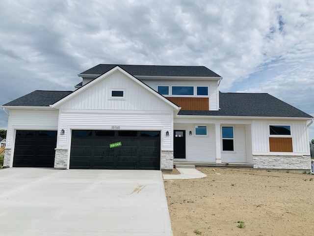 15765 Norwalk Rd, Grand Haven, MI 49417 - modern farmhouse featuring stone siding, a garage, board and batten siding, driveway, and covered porch