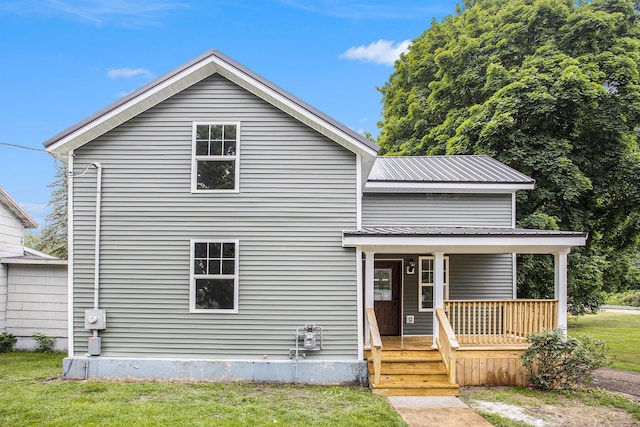 103 W Pearl St, Marshall, MI 49068 - view of front of home featuring covered porch, metal roof, and a front yard