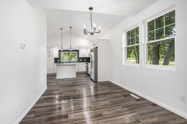 103 W Pearl St, Marshall, MI 49068 - kitchen with stainless steel appliances, white cabinets, a center island, baseboards, and vaulted ceiling