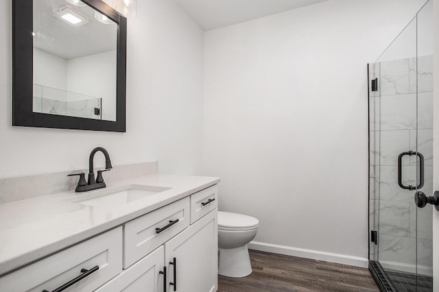 103 W Pearl St, Marshall, MI 49068 - full bath featuring vanity, toilet, wood finished floors, a marble finish shower, and baseboards