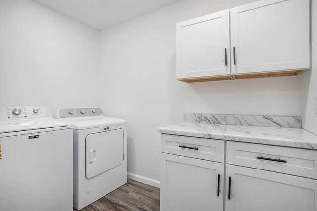 103 W Pearl St, Marshall, MI 49068 - laundry area with cabinet space, washing machine and dryer, wood finished floors, and baseboards