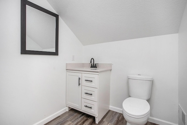 103 W Pearl St, Marshall, MI 49068 - bathroom featuring vaulted ceiling, wood finished floors, vanity, toilet, and baseboards