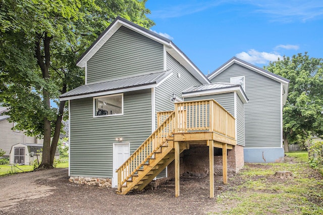 103 W Pearl St, Marshall, MI 49068 - back of house featuring stairs, metal roof, and a deck