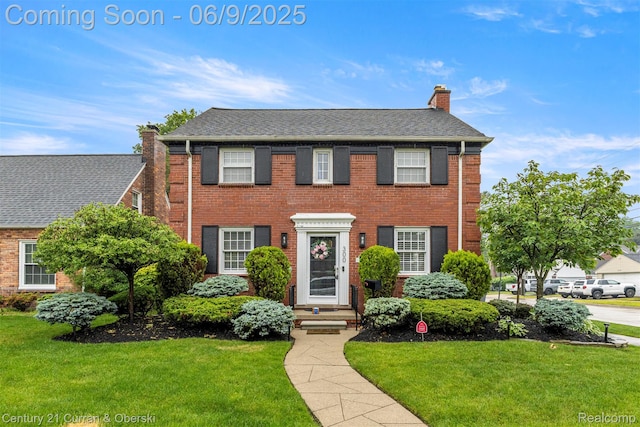 300 S Melborn St, Dearborn, MI 48124 - colonial home with a chimney, a front lawn, and brick siding