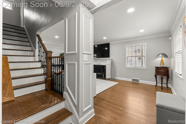 300 S Melborn St, Dearborn, MI 48124 - stairway featuring ornamental molding, wood finished floors, a high end fireplace, recessed lighting, and baseboards